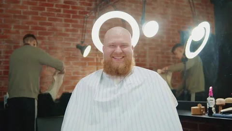 A man sits under a ring lamp as if with a halo on his head. Stock Footage 143384853