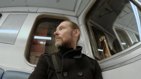 Man sits in the underground carriage 動画素材 153616807