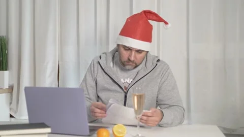 Man sits working at a laptop during the new year Stock Footage 167949083