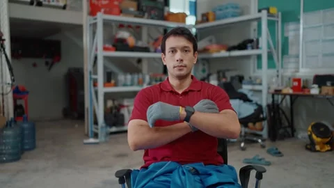 Man sits in workshop, arms crossed Stock Footage 339050288