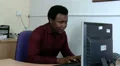 Man sitted at desk typing stands and continues his work HD Footage