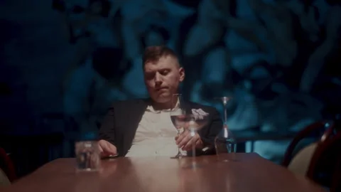 Man sitting alone and drinking alcohol Stock-Footage 258334726