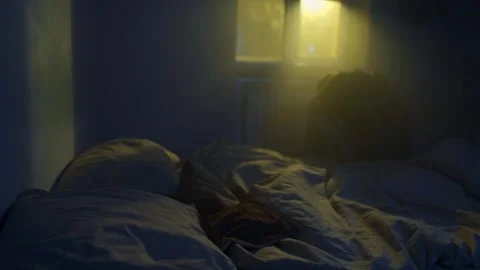 Man sitting alone on bed after relationship breakup, emotional pain and Stock-Footage 321710536