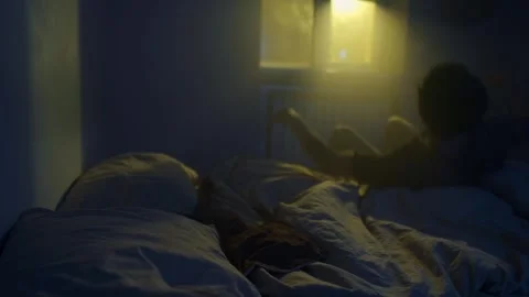 Man sitting alone on bed in dark room, emotional exhaustion and disappointment Stock-Footage 321710575