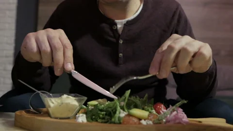 A man is sitting alone in a cafe and enjoying a seafood salad. Salad with Lasso 스톡 동영상 108596702