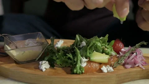 A man is sitting alone in a cafe and enjoying a seafood salad. Salad with Lasso 스톡 동영상 108597302