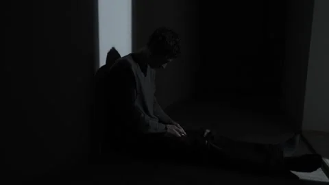 Man sitting alone in the dark after texting on phone, feeling ghosted Stock Footage 324820133