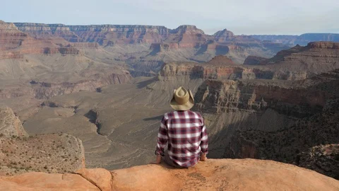 Man Sitting Alone On Edge Of The Abyss Looking Amazing View Of Grand Canyon Stock Footage 91003217