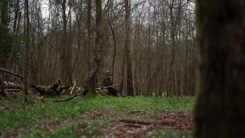 A man sitting alone in a forest, he is drinking something and looking relaxed Vidéo 277261975