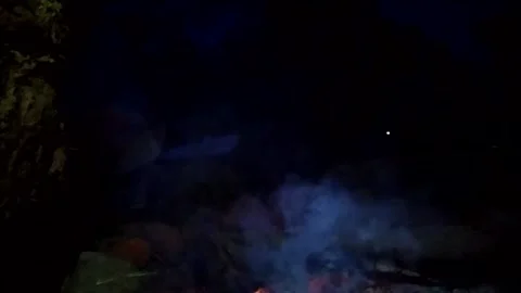 A man sitting alone in front of campfire bonfire at indonesian family fun campin Video stock 151301888