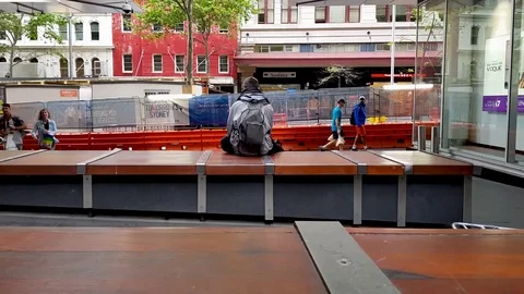 Man Sitting Alone in a walkway Stock Footage 82262482