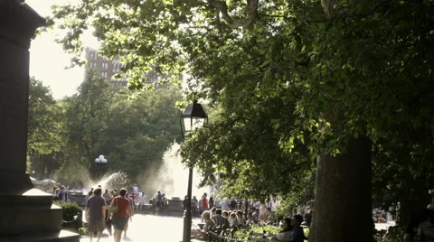 Man sitting alone in Washington Square Park on bright sunny day NYC in 1080 HD Stock Footage 64738116