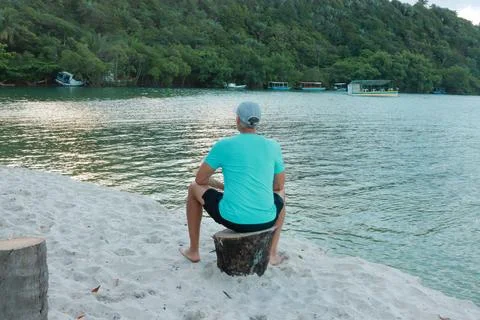 Man sitting and looking out over the river Stock Photos