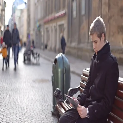 A man sitting and typing on the tablet Stock Footage 69590450