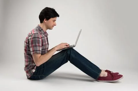 Man sitting and using a laptop Stock Photos