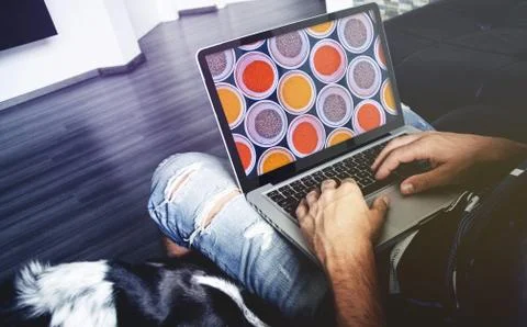 Man sitting and using laptop Stock Photos