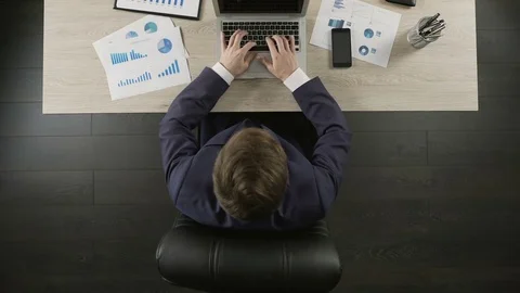 Man sitting back in office chair relaxed and satisfied with business project Stock Footage