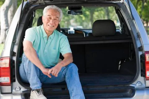 Man sitting in back of van smiling Stock Photos