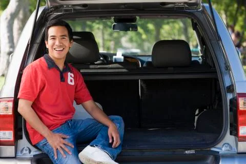 Man sitting in back of van smiling Stock Photos