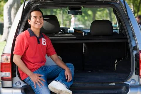 Man sitting in back of van smiling Stock Photos