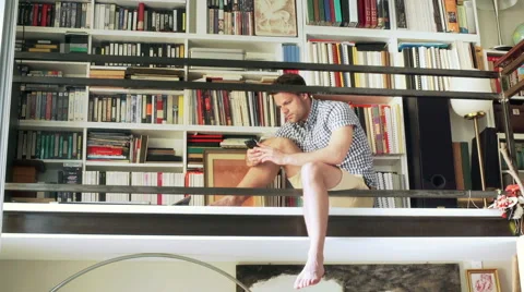 Man sitting on the balcony and using smartphone Stock Footage 52099435