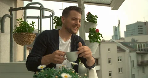 Man sitting on balcony Stock Footage 103142435