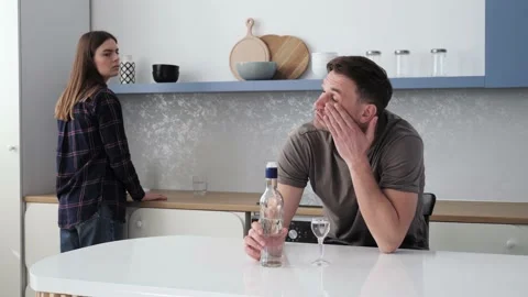 Man sitting at bar counter drinking alcoholic drink upset exhausted his wife. Video stock 150296495