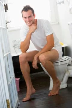 Man sitting in a bathroom Stock Photos