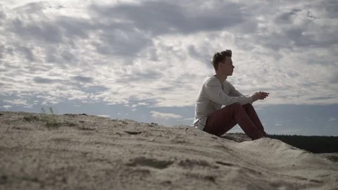 Man sitting on beach Stock Footage 80709082