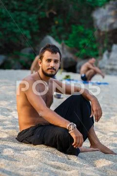 Man sitting on a beach Stock Photos