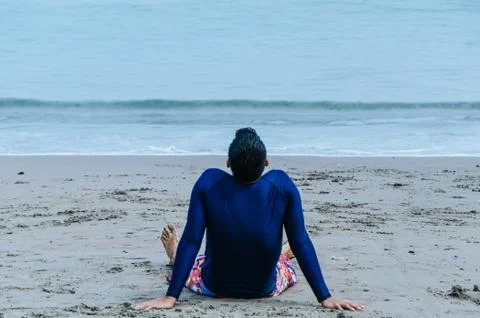 Man sitting on beach Stock Photos