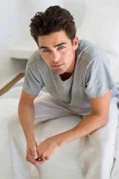 Man sitting on the bed Stock Photos