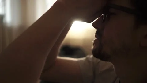 Man sitting on bedroom floor and praying for divine help, asking for divine Stock Footage 314710802