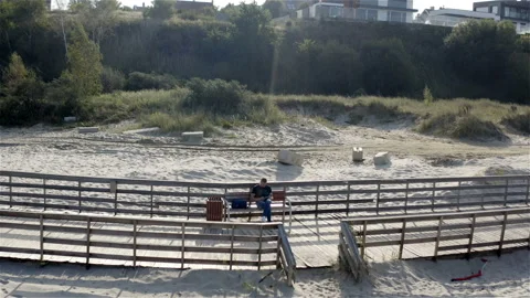 Man sitting on a bench examining a cellphone Stock Footage 117629039