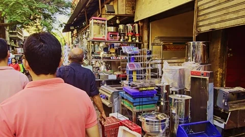 A man sitting on a bench in front of a store Stock Footage 292248662