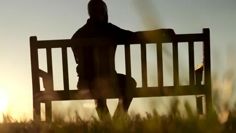 Man sitting on a bench by the lake Video stock 141230898