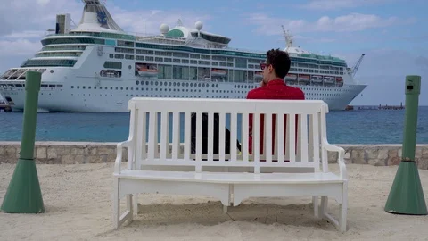 Man sitting on bench, looking at vessel and smoke Stock Footage 108919596