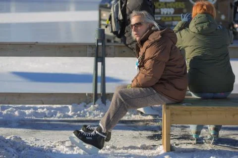A man sitting on a bench Stock Photos