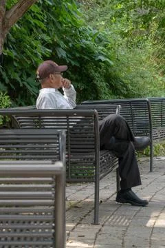 Man sitting on bench Stock Photos