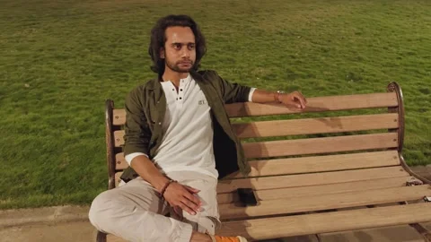 Man sitting on a bench with thoughts Stock Footage 276775656