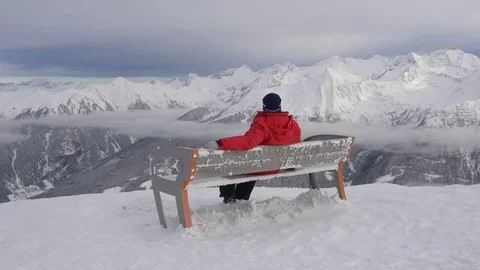 Man sitting on a bench at the top of the mountain Stock Footage 71414371