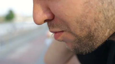 A man sitting at the bike path, talking, eating noodles funchoza, talking. Profi Stock Footage 112121233