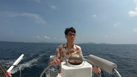 A man is sitting in a boat and looking out at the water Stock Footage 314456344