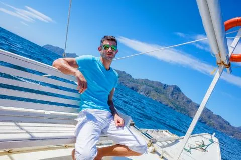 Man sitting on boat deck Stock-Fotos