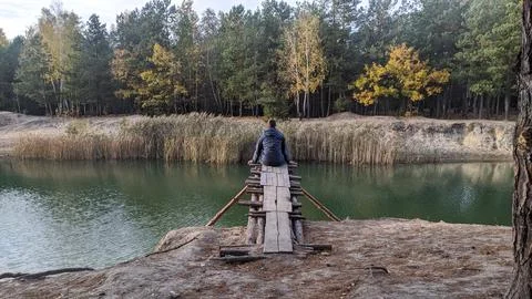 Man sitting on a bridge Stock Photos