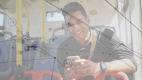 Man sitting on bus tapping phone, causing tech network graphs shifting and Stock Footage 332282052