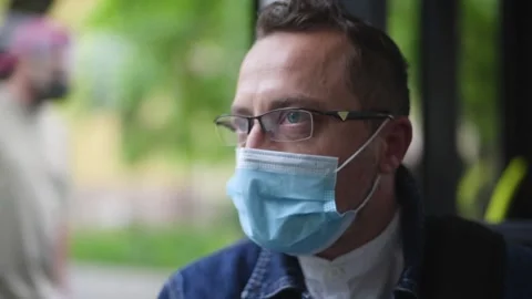Man sitting on the bus wearing face mask during coronavirus pandemic. Stock Footage 156190752