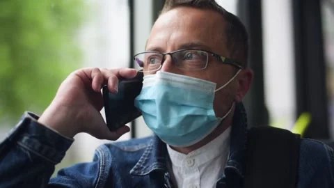 Man sitting on the bus wearing face mask during coronavirus pandemic. Stock Footage 156190996