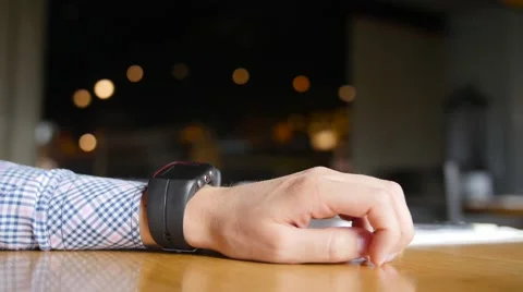 Man sitting in a cafe and using his smart watch. Close up view of hands Видео 64049280