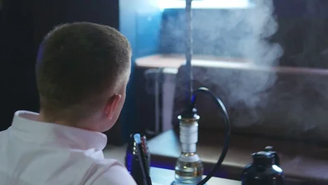 A Man is Sitting in a Cafe in Front of a Hookah Stock Footage 75259174